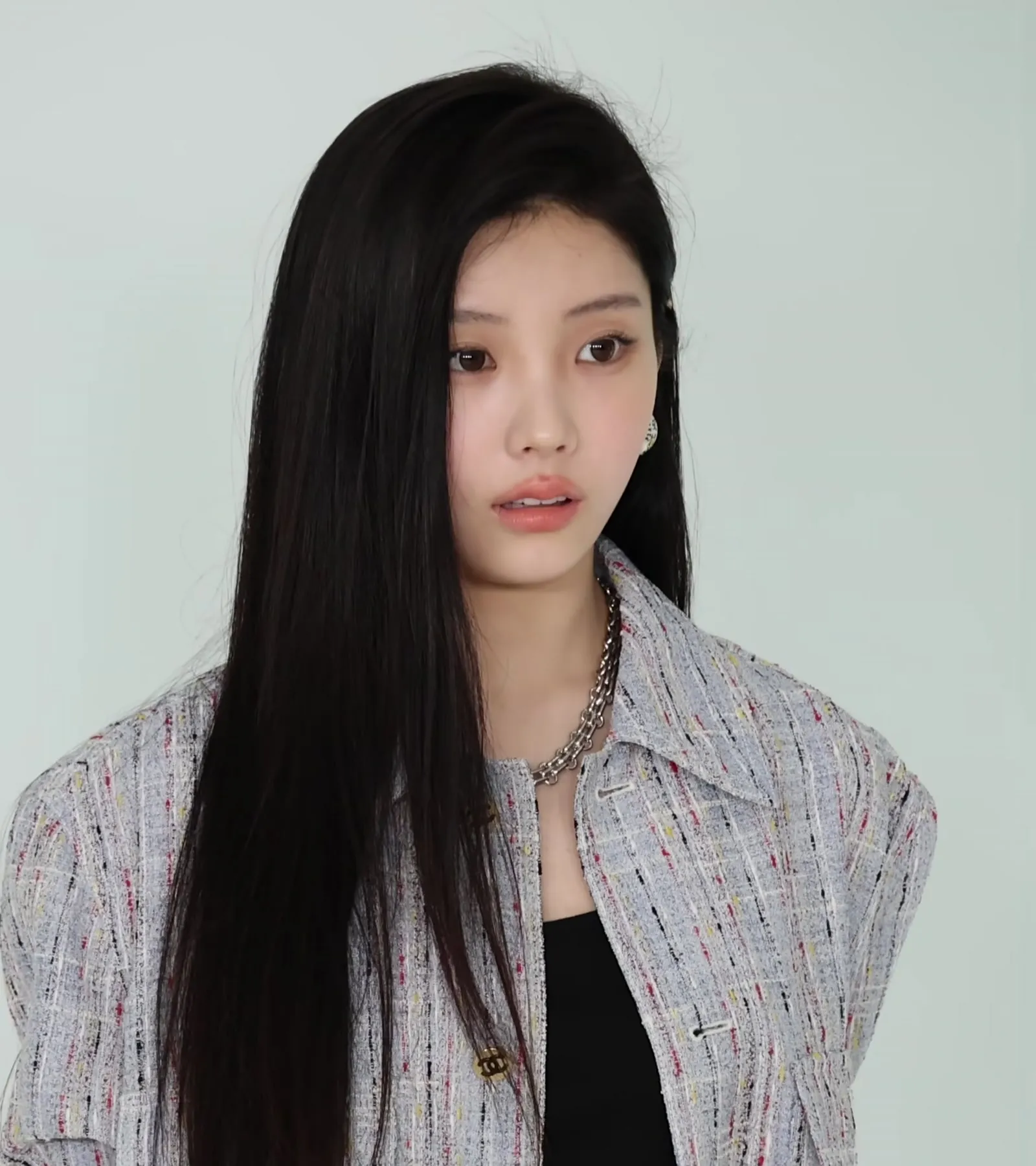 WONHEE of ILLIT looks at the camera in a tweed jacket at the photo wall of a fashion brand collection event held in Seoul on 26 May 2026.